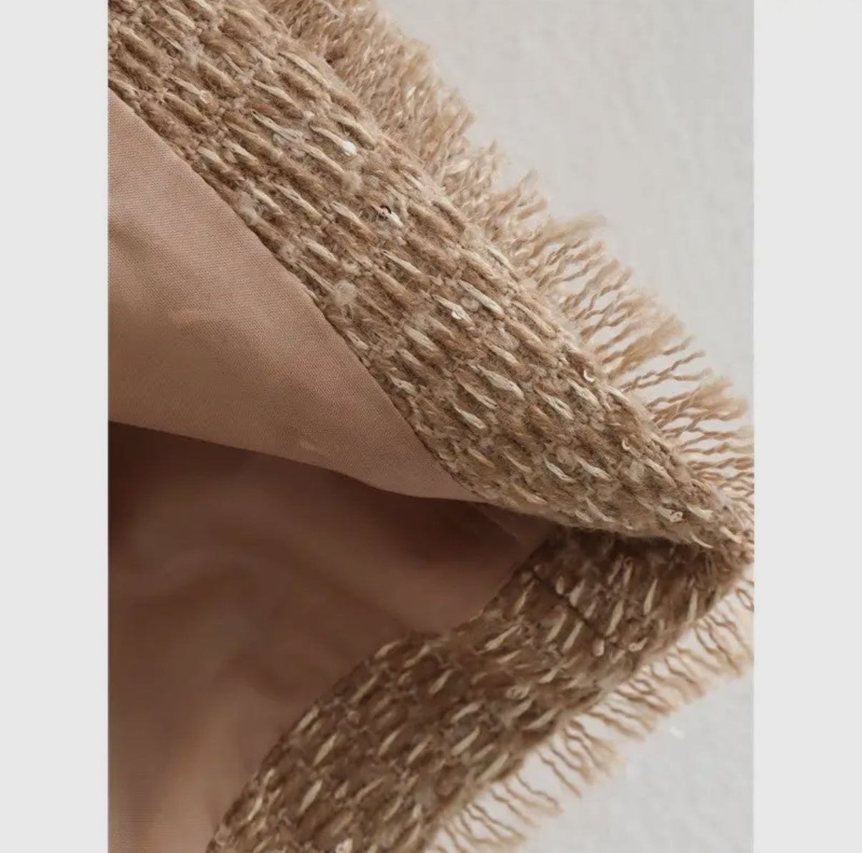 Lining detail of a beige tweed blazer