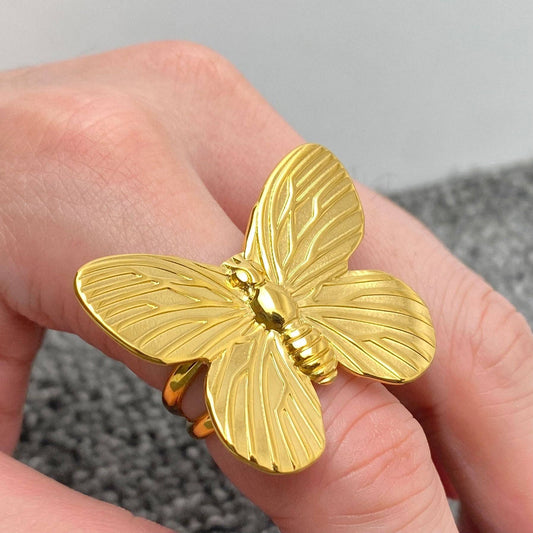 gold butterfly cocktail ring on hand