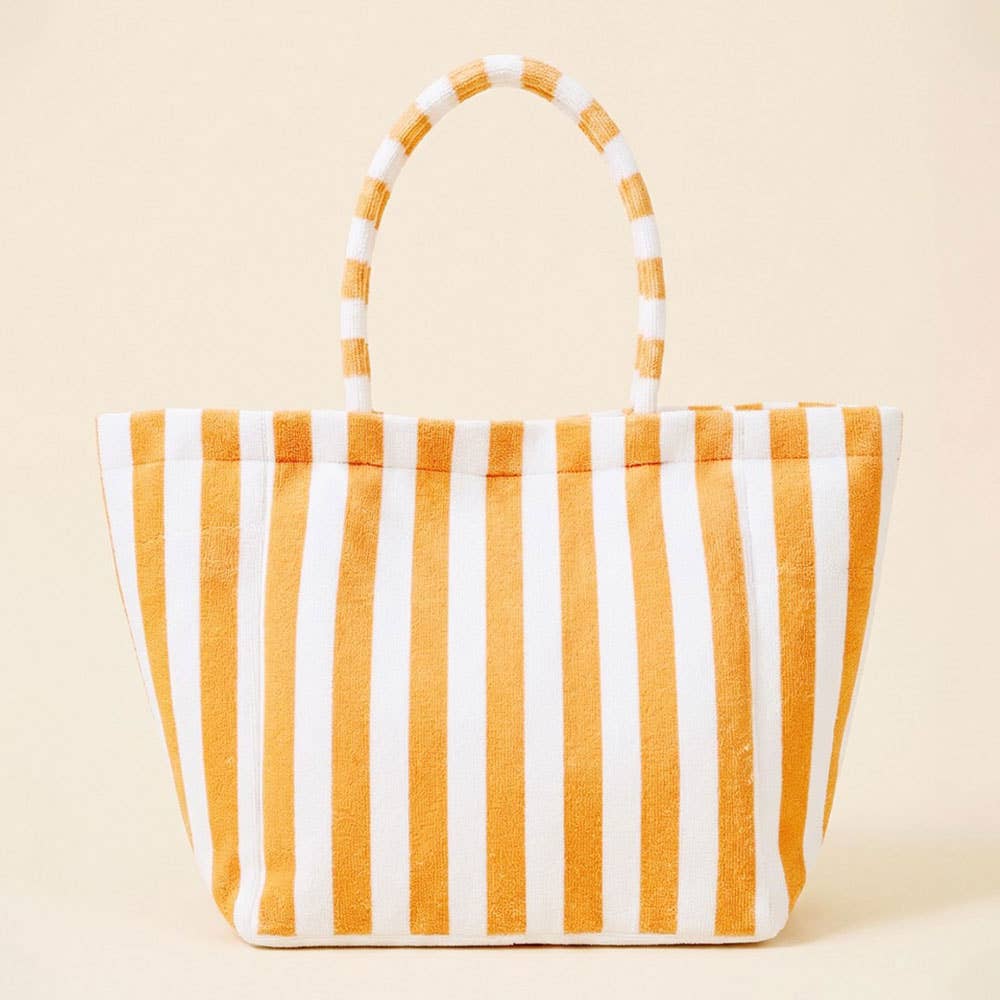 Striped terrycloth tote bag with orange and white stripes on a beige background