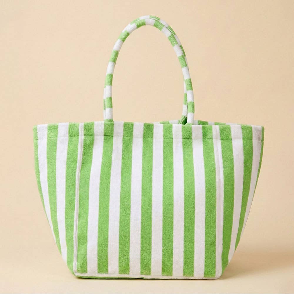 Green and white striped tote bag on a beige background