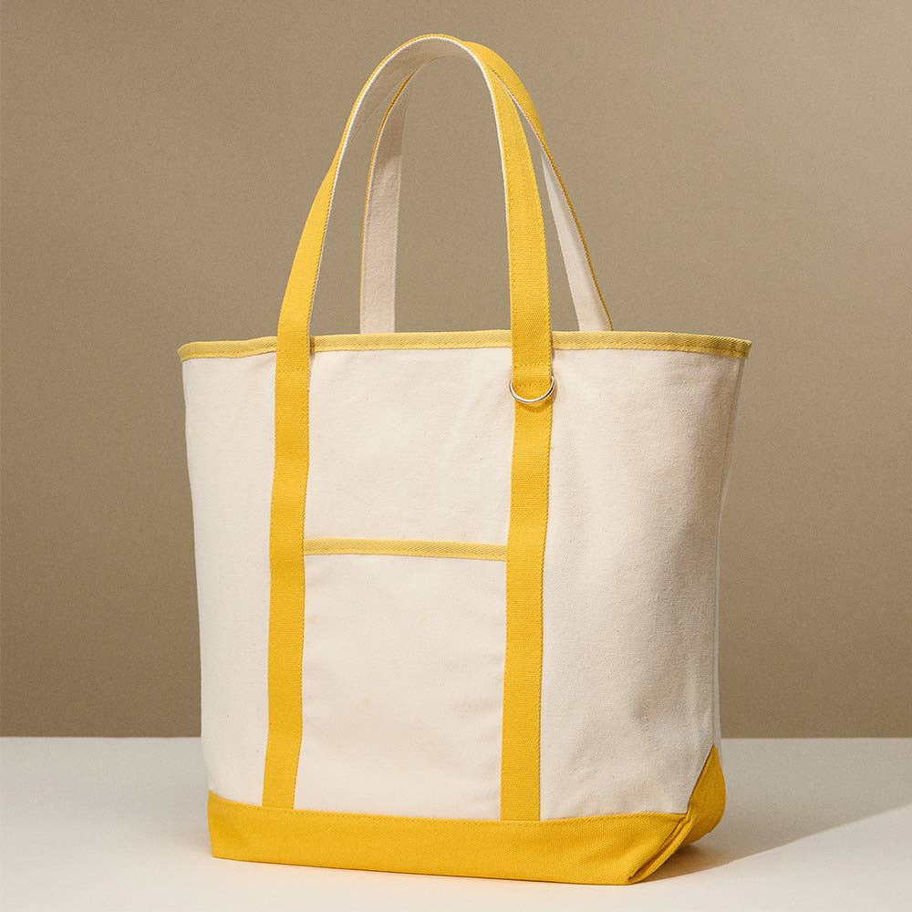 White tote bag with yellow accents on a beige background