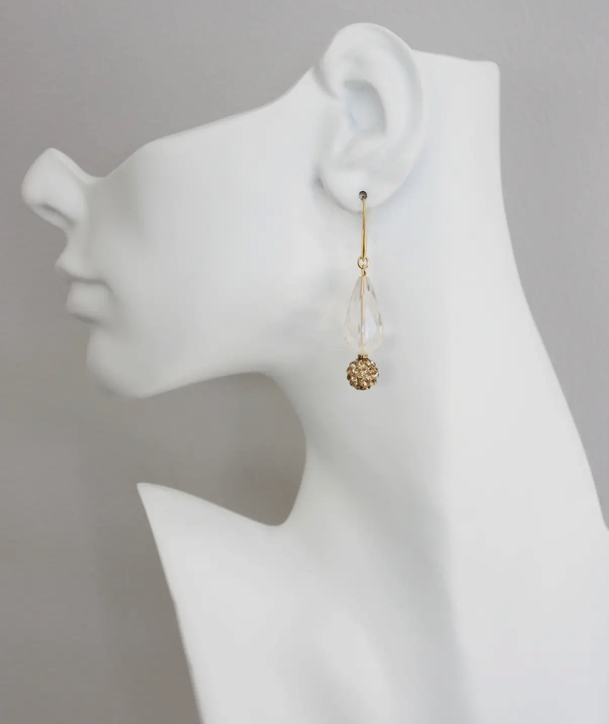 Crystal and topaz earring on mannequin