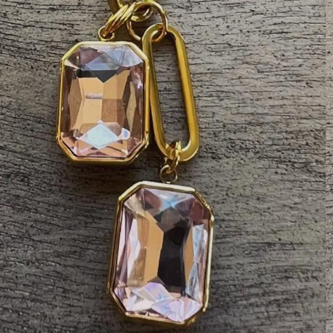 Gold chain necklace with pink crystal double drop pendant close-up