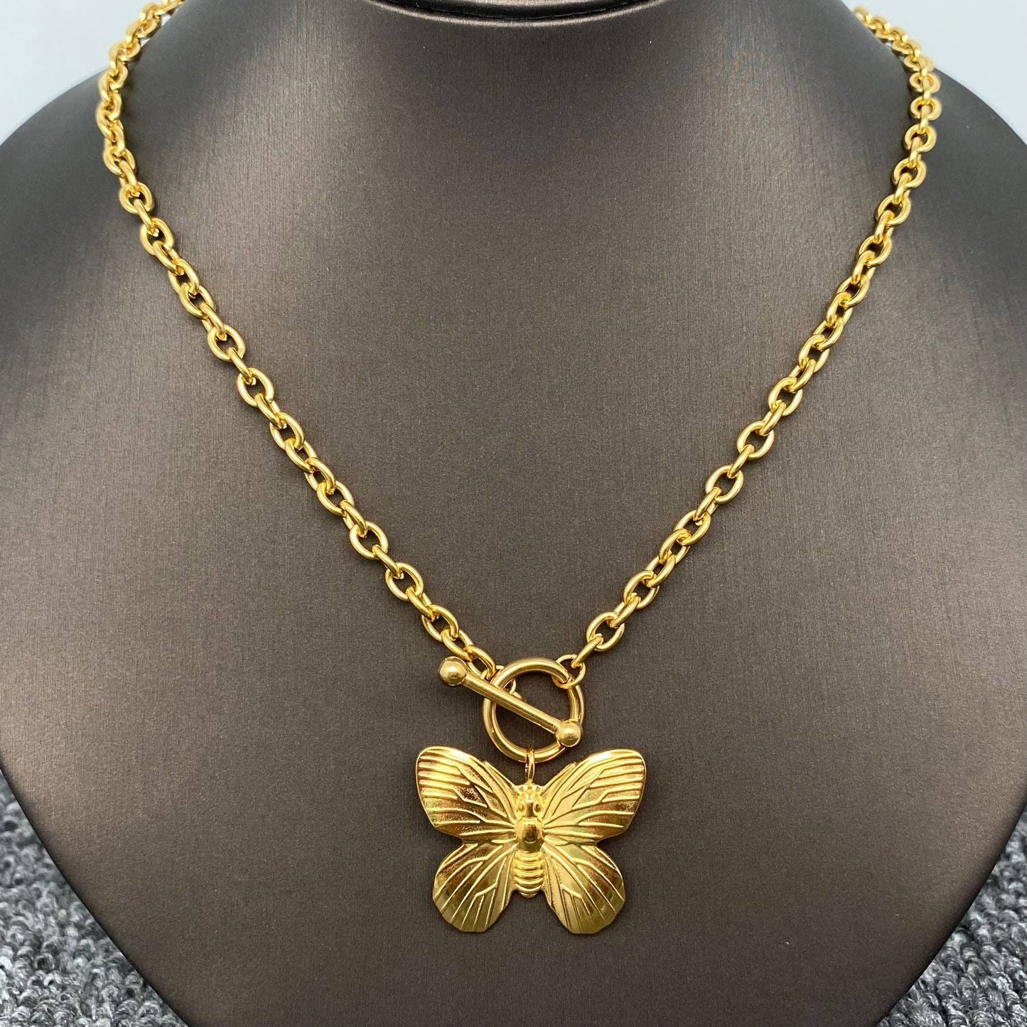 Gold chain toggle necklace with butterfly charm