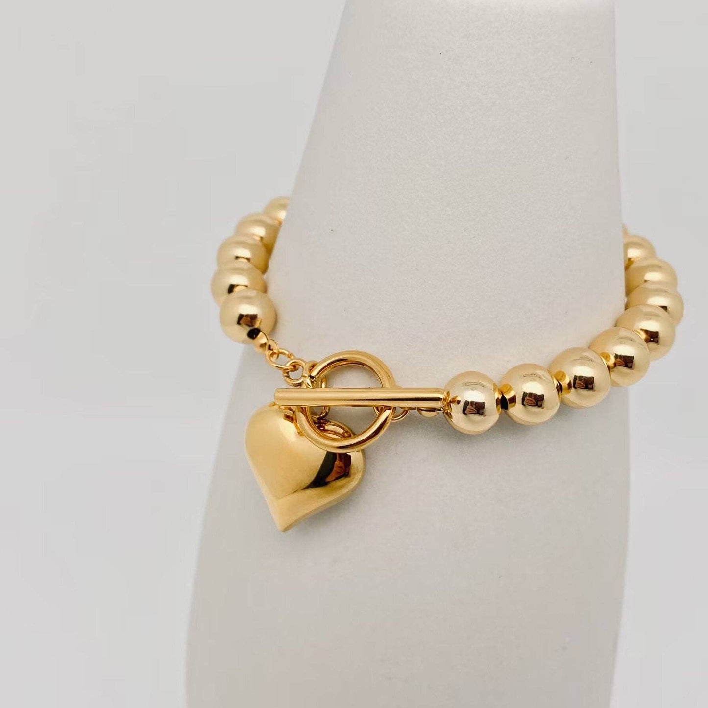 gold bead bracelet with puffy heart charm and toggle clasp
