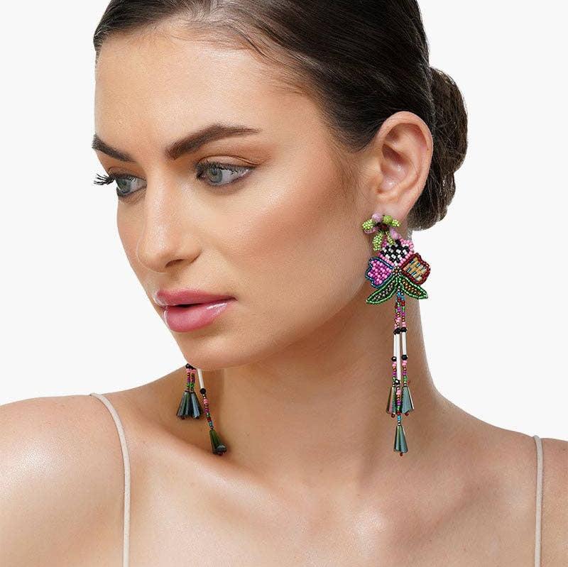 woman wearing beaded flower multi colored dangle earrings