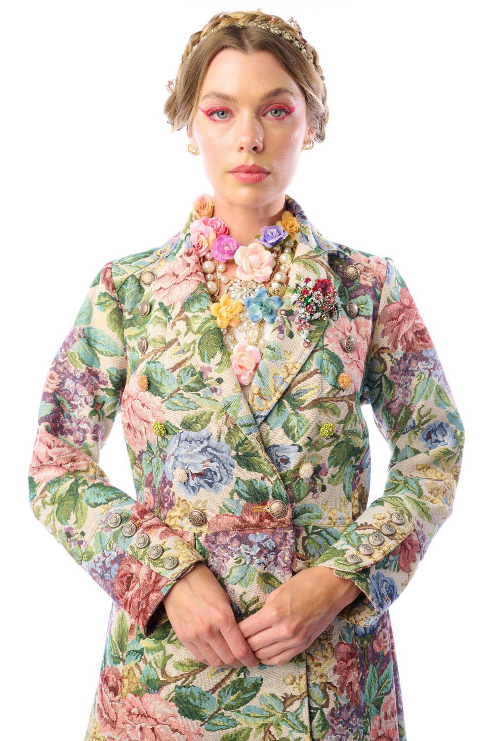 Woman wearing a floral patterned coat on a white background