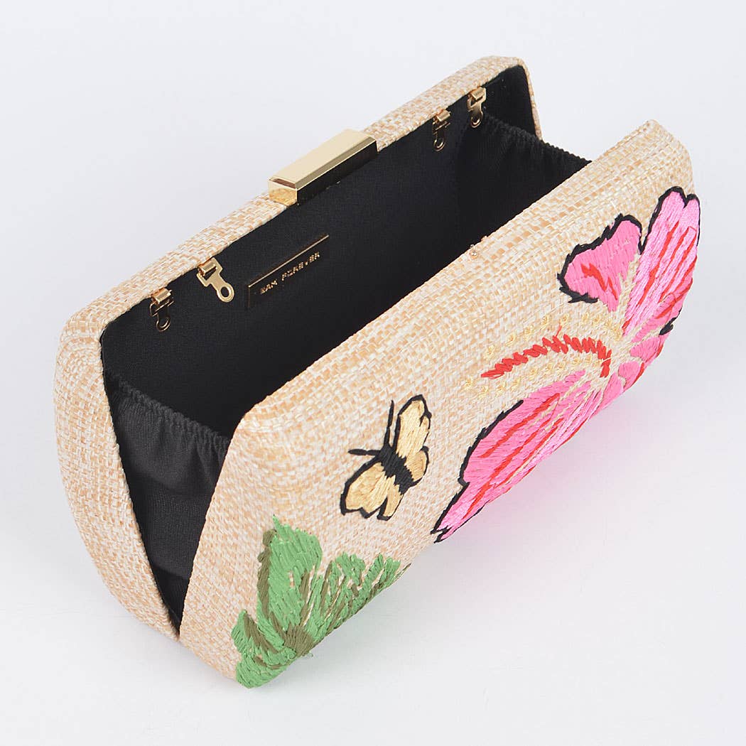 raffia clutch opened with black interior lining and butterfly and floral embroidery on the outside