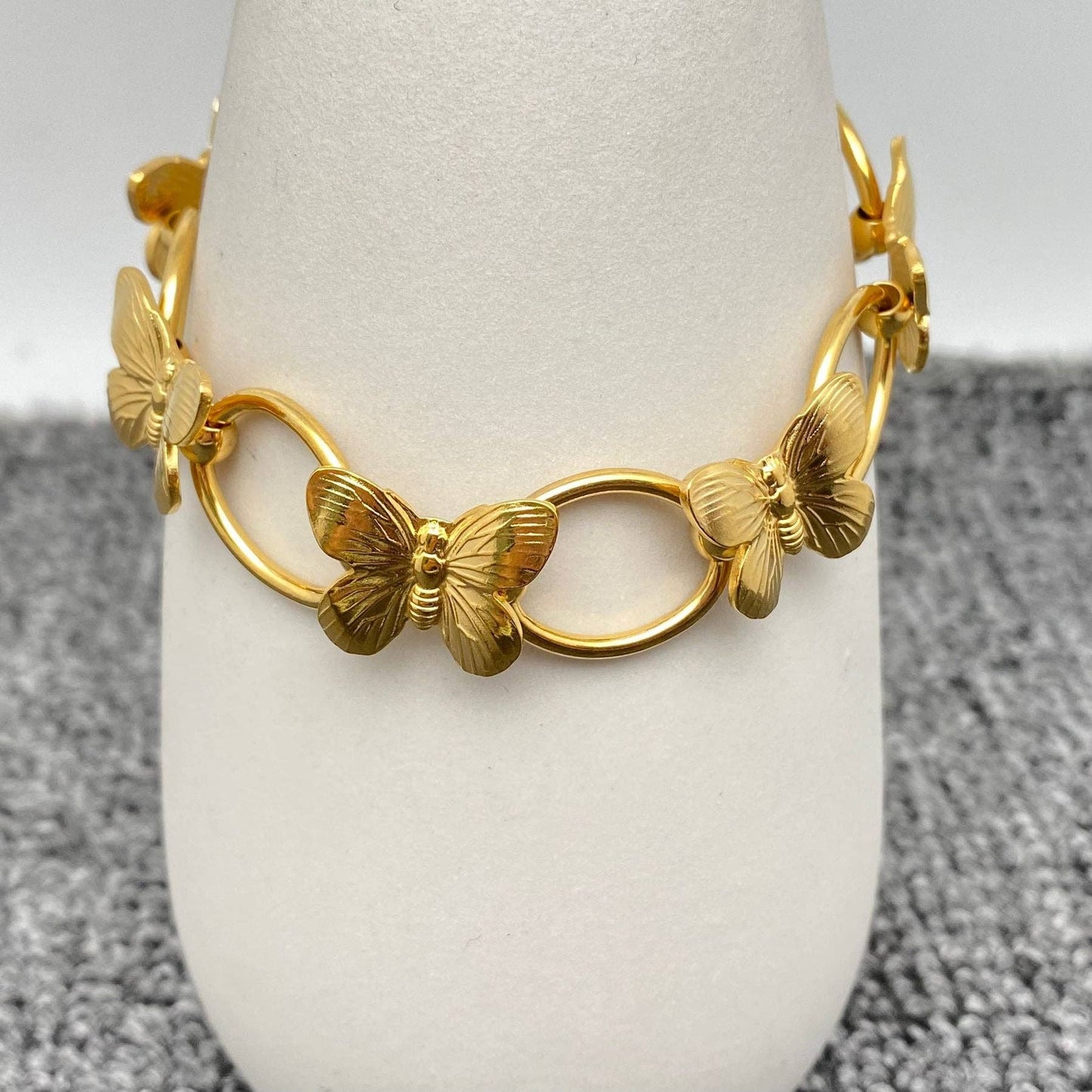 white stand with gold butterfly link bracelet