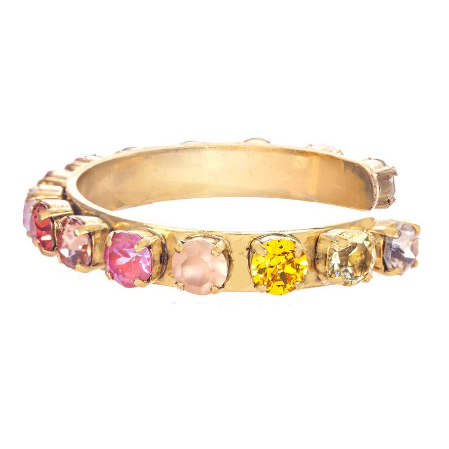 Close-up of rainbow ombré crystal cuff bracelet showing faceted crystal detail and gold brass band