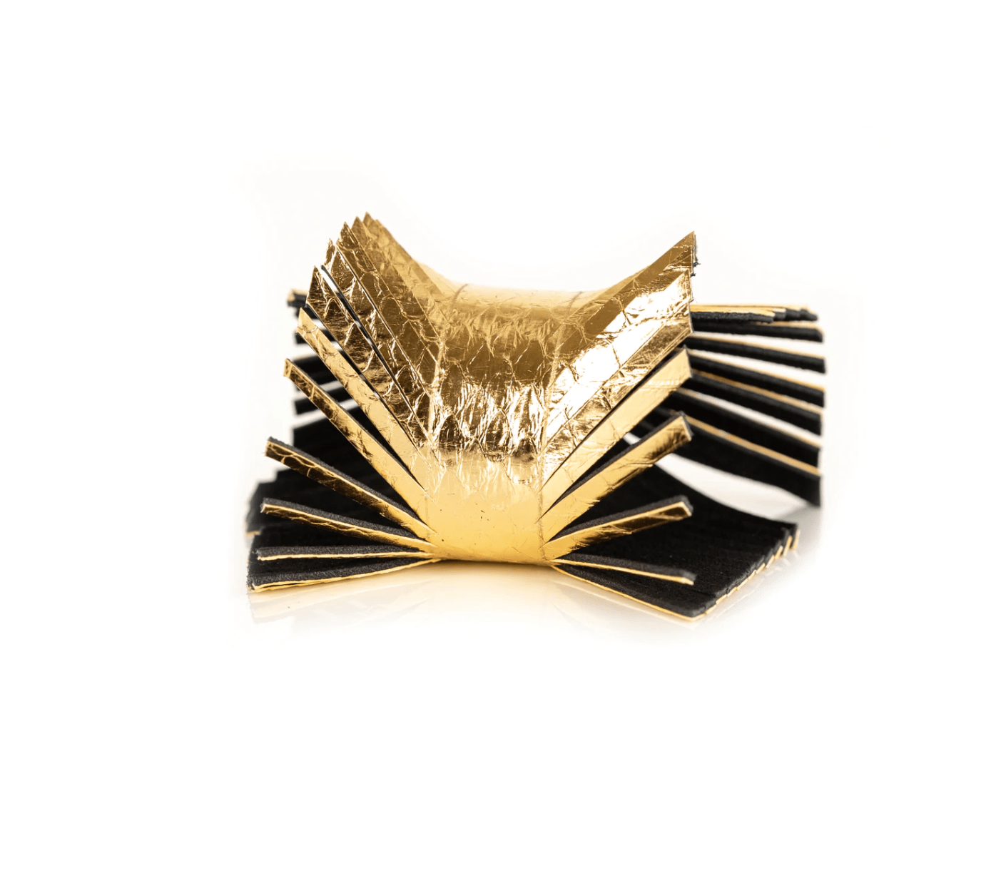 Gold snakeskin embossed leather bracelet with fringe detail against a white background