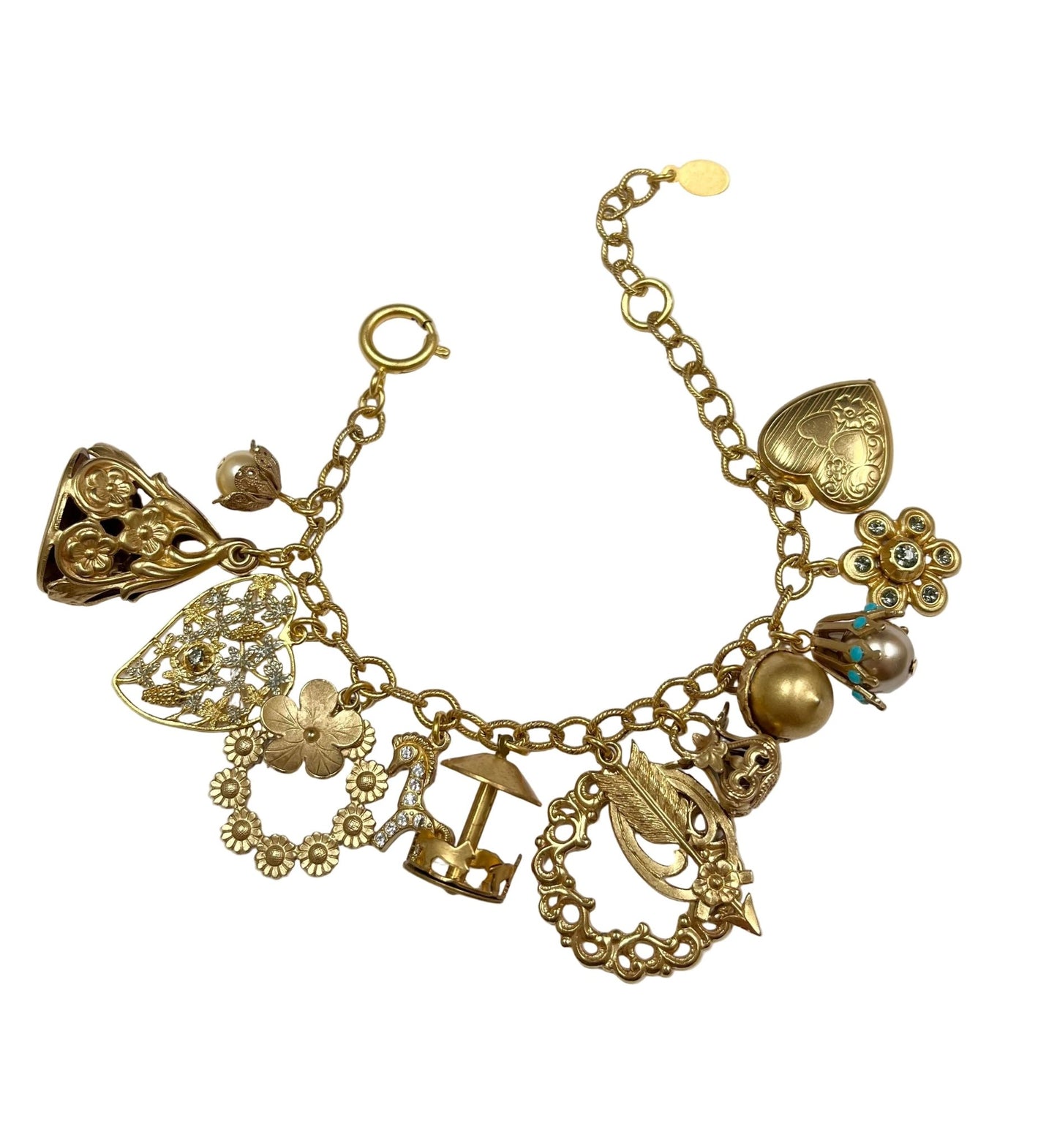 Gold charm bracelet with various charms on a white background