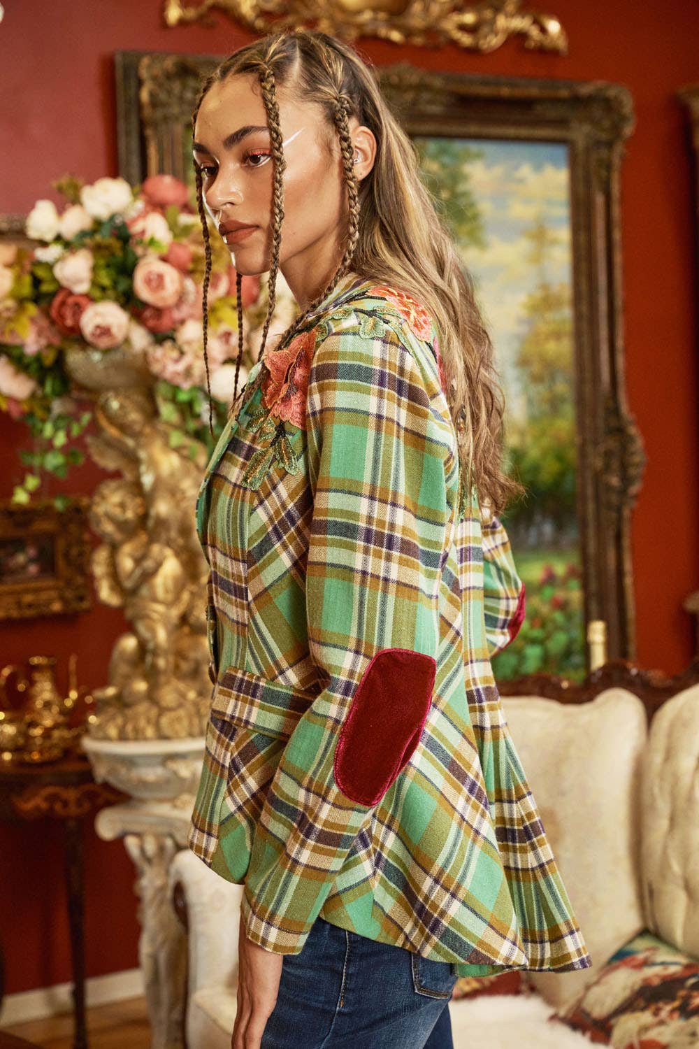 side view of woman wearing green plaid blazer and jeans