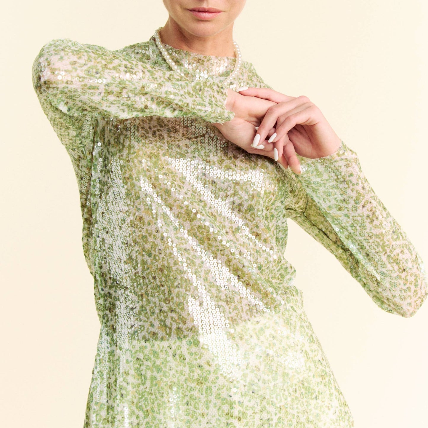 woman wearing a green sequin top