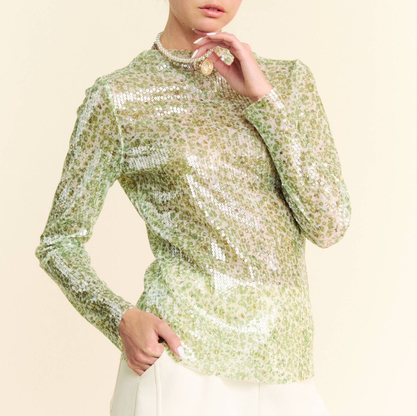 woman wearing a green sequin top