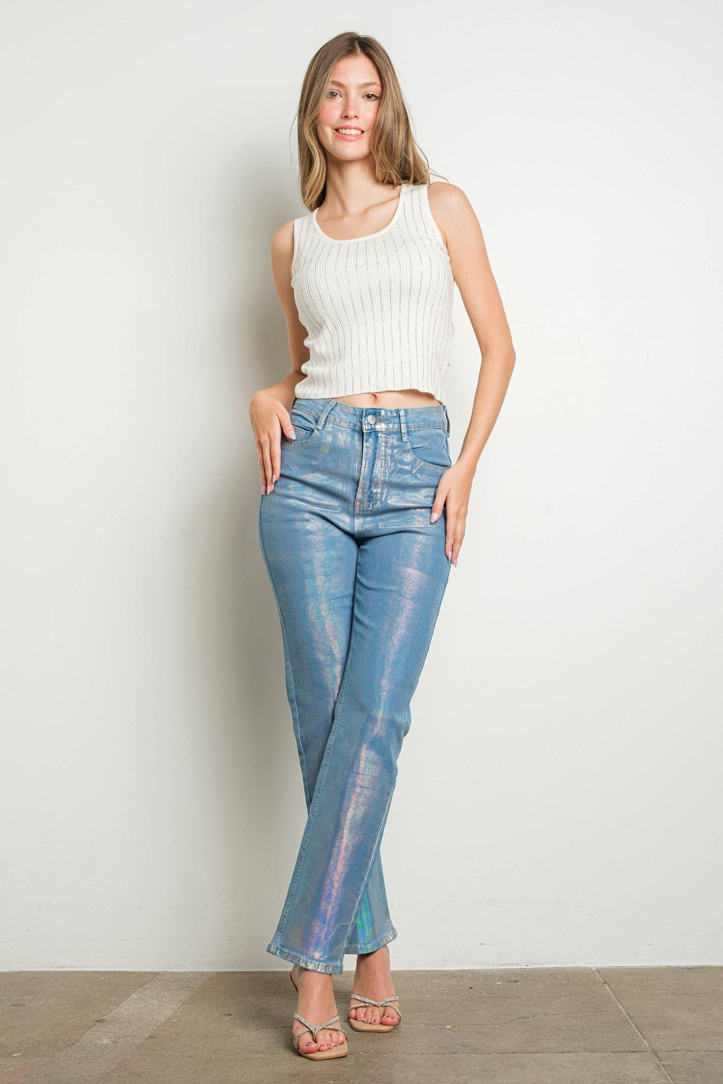 Woman in white tank top and iridescent jeans