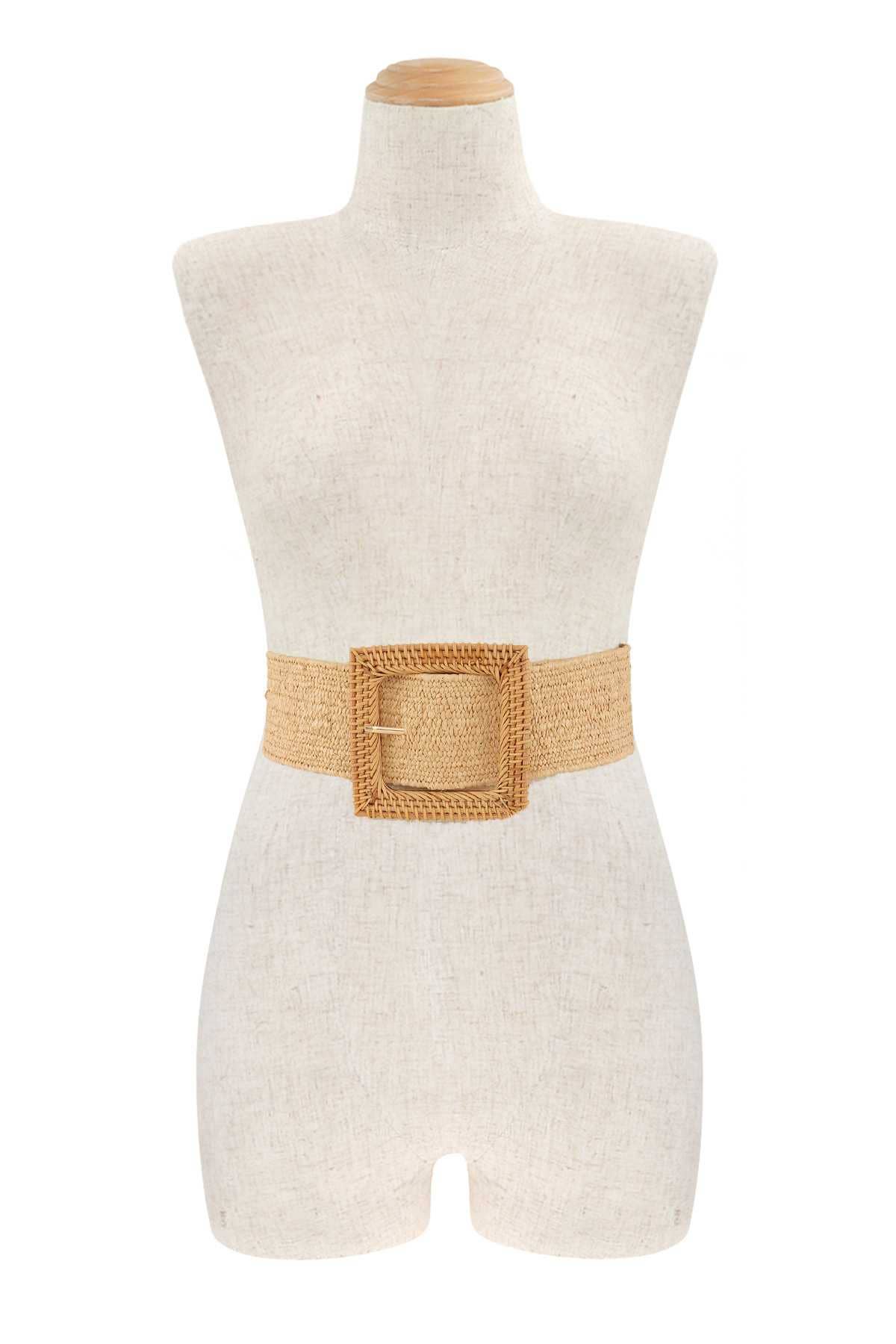 mannequin wearing a large rattan wrapped square buckle stretchy elastic belt against a white background