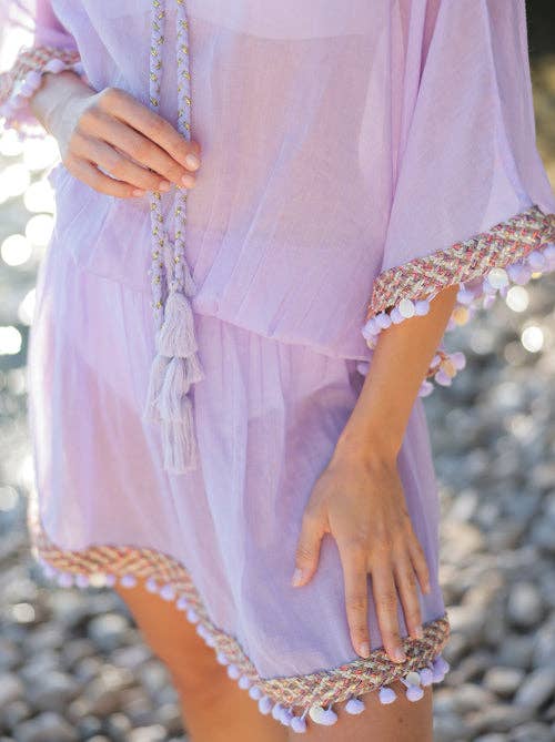 up close view of woman wearing lavender swimsuit coverup