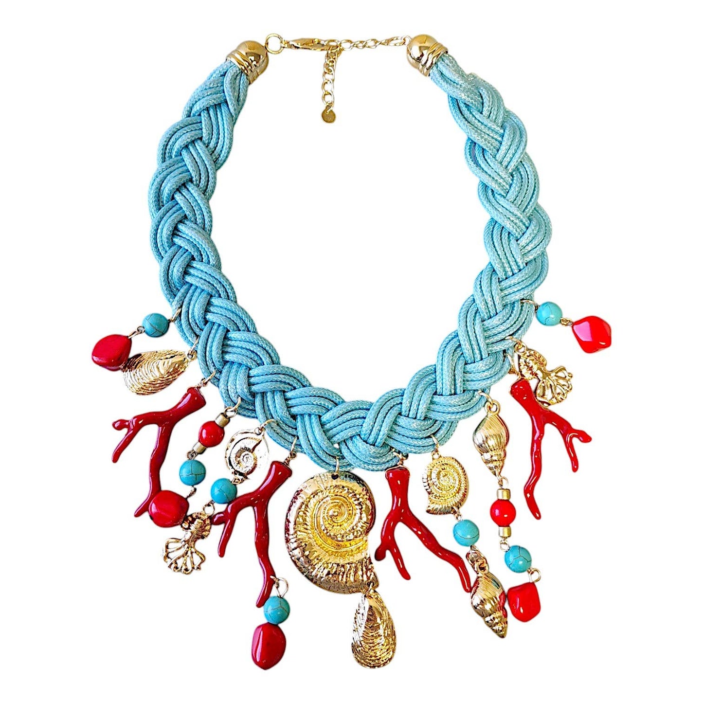 turquoise, red, and gold charms on a turquoise braided necklace against a white background