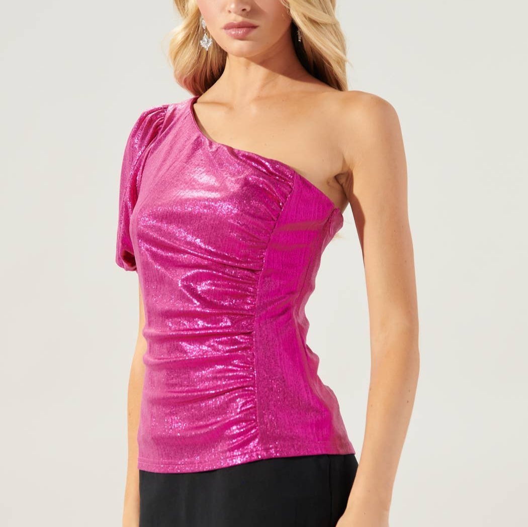 Woman wearing a pink one-shoulder top against a plain background