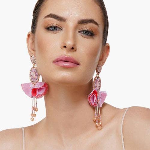 woman wearing pink beaded dangle earrings