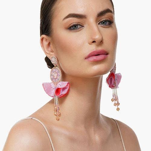 woman wearing pink beaded dangle earrings