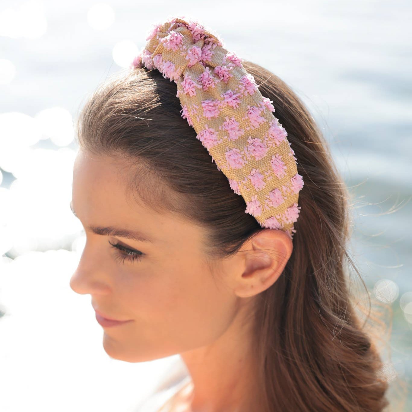 woman wearing pink and tan raffia headband