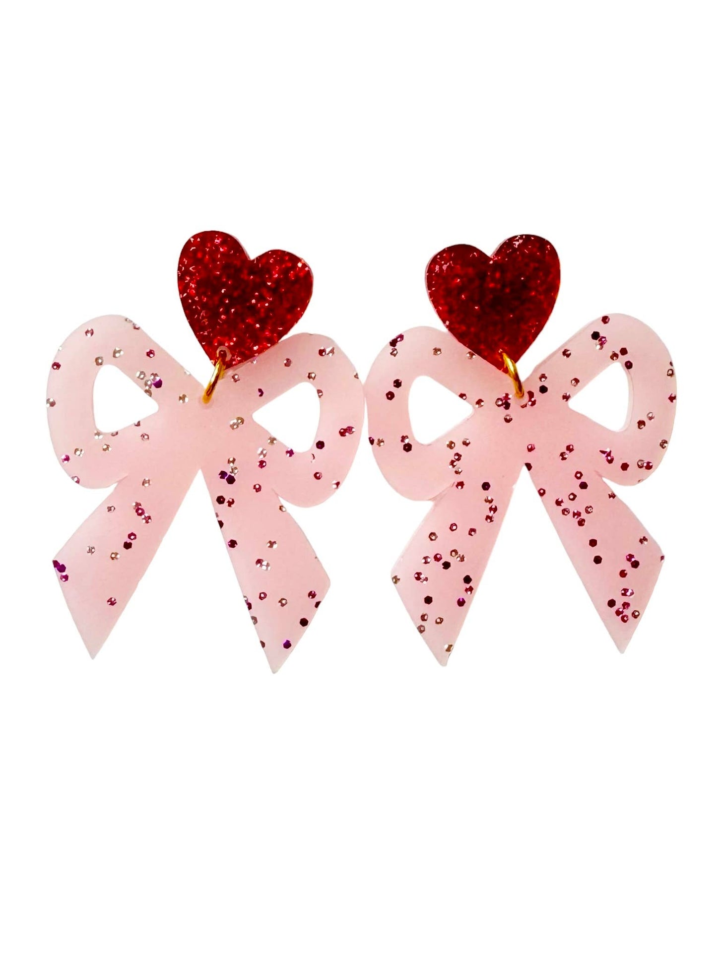 Pink acrylic bow earrings with red glitter heart toppers on white background