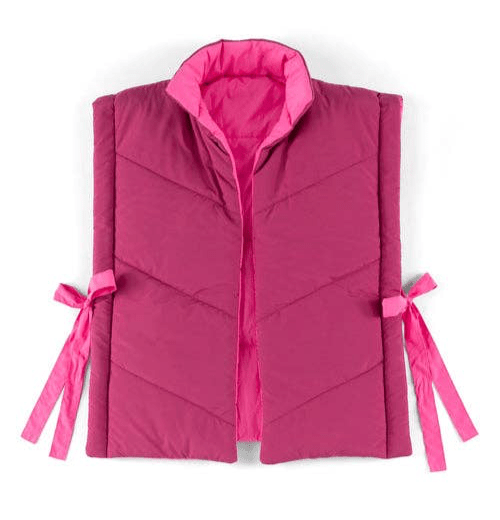 Flay lay of reversible side tie vest on a white background