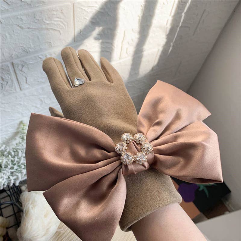 a pair of gloves with satin bow and crystal embellishment
