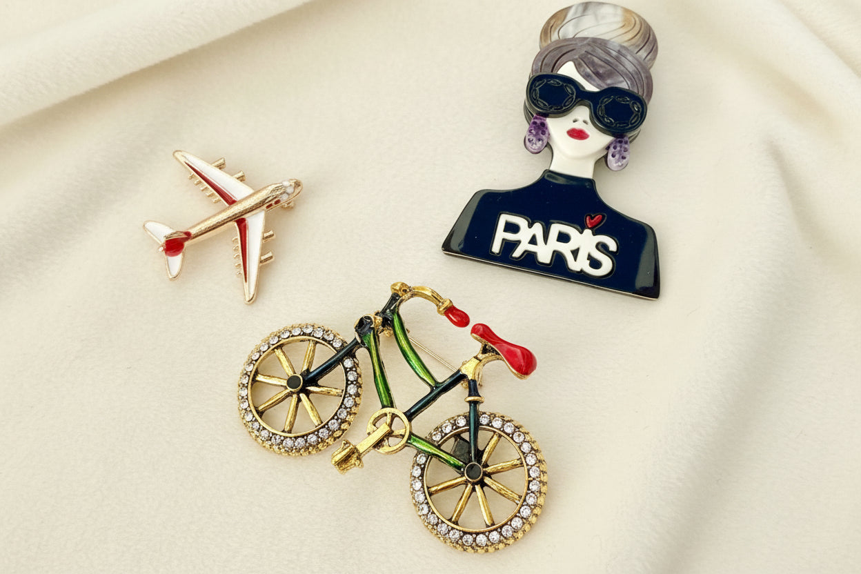 Bicycle-shaped brooch with rhinestones on a white background