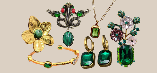 Emerald green jewelry including earrings, a bracelet, brooches, a necklace, and a ring from JuJu Loves