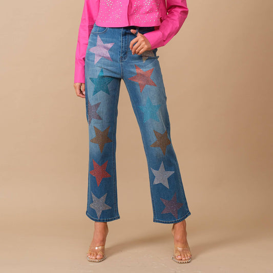 Embellished Jeans are the statement you didn't know you your closet was missing featuring a woman wearing star embellished jeans against a beige background