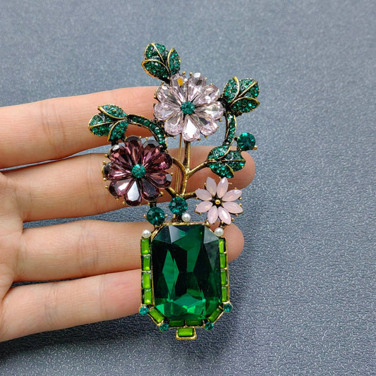 best vintage style brooches under $100 featuring a crystal green crystal vase and flowers