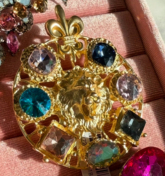 Brooches are Trending featuring a large gold lion filigree brooch with crystal accents