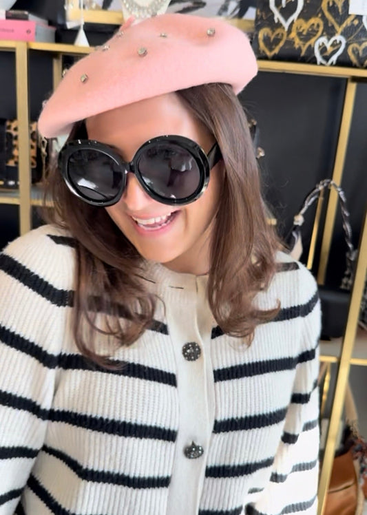 French Girl accessories and aesthetic featuring pink beret and black round sunglasses in an indoor setting