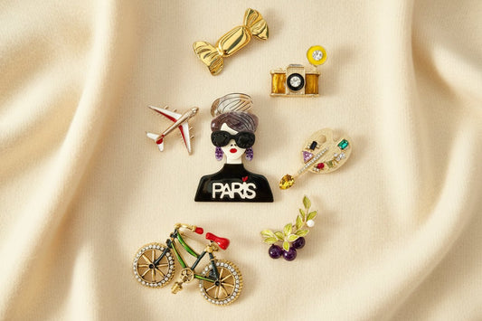 Build you dream brooch collection featuring various brooches against an ivory fabric background 