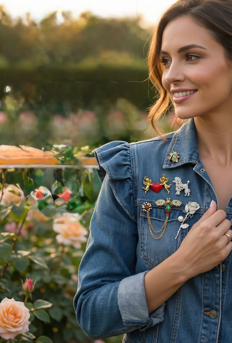 A woman in a denim jacket wearing 5 decorative brooches in a garden background