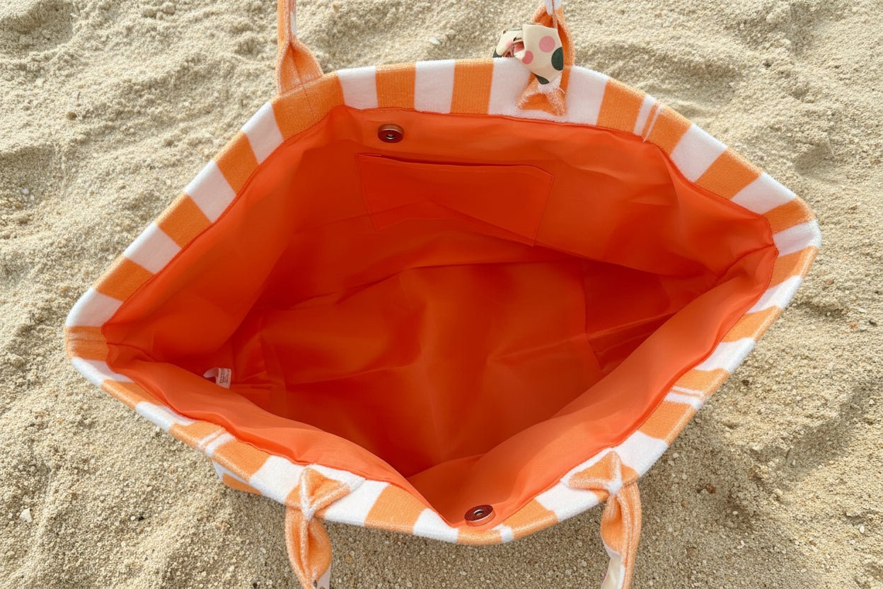 Close-up of the inside of coral striped terrycloth tote bag showing magnetic closure and inner slip pocket