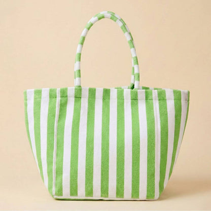 Green and white striped tote bag on a beige background