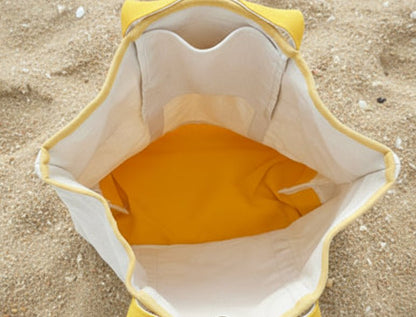 Close-up of a yellow fabric inside a beige bag