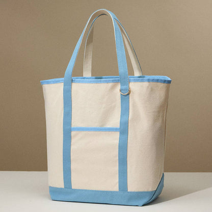 Beige canvas tote bag with light blue accents on a beige background