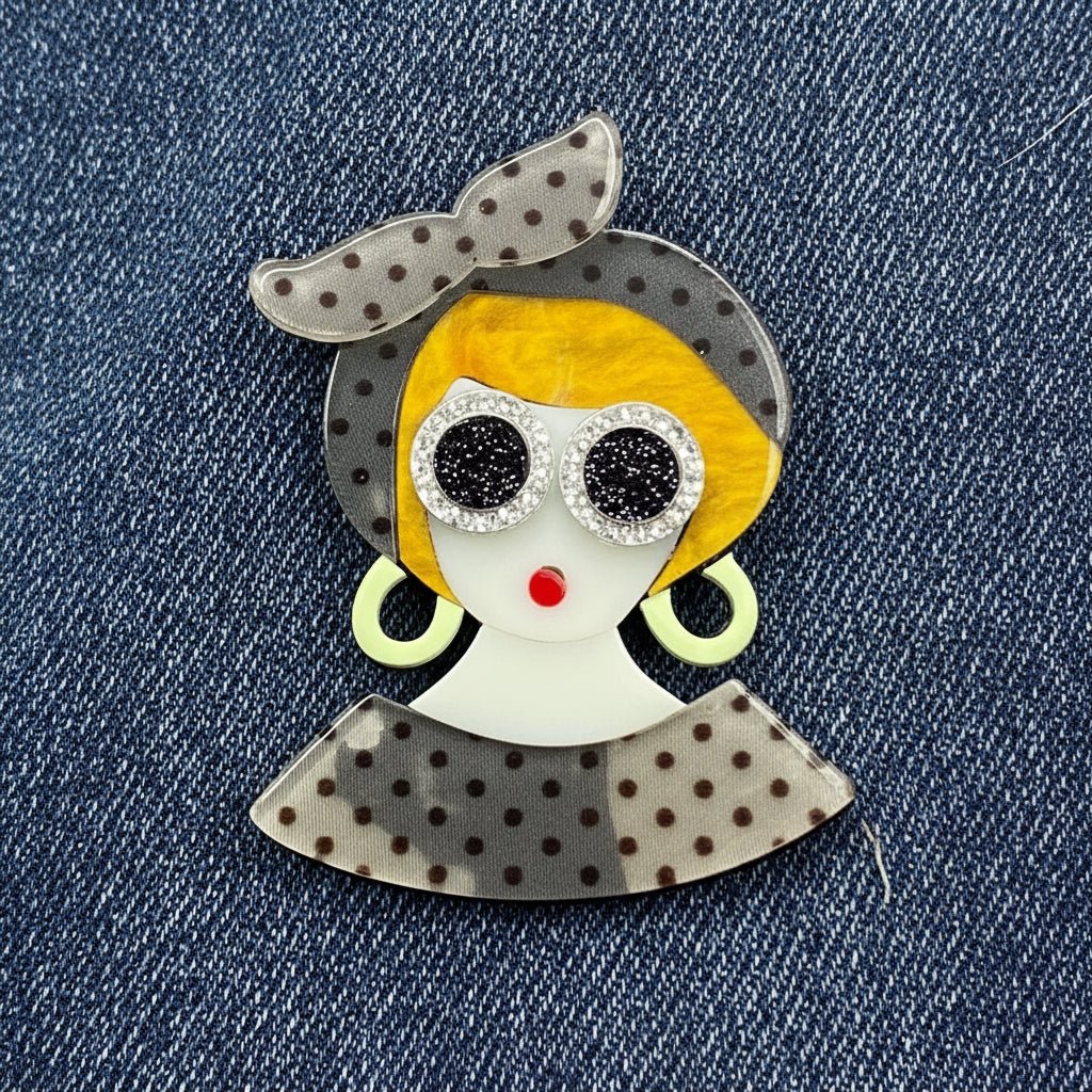 Fashionista brooch against denim fabric