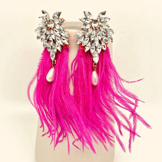 a pair of pink feather and rhinestone encrusted earrings