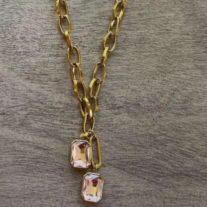 gold chain with two pink crystal pendants