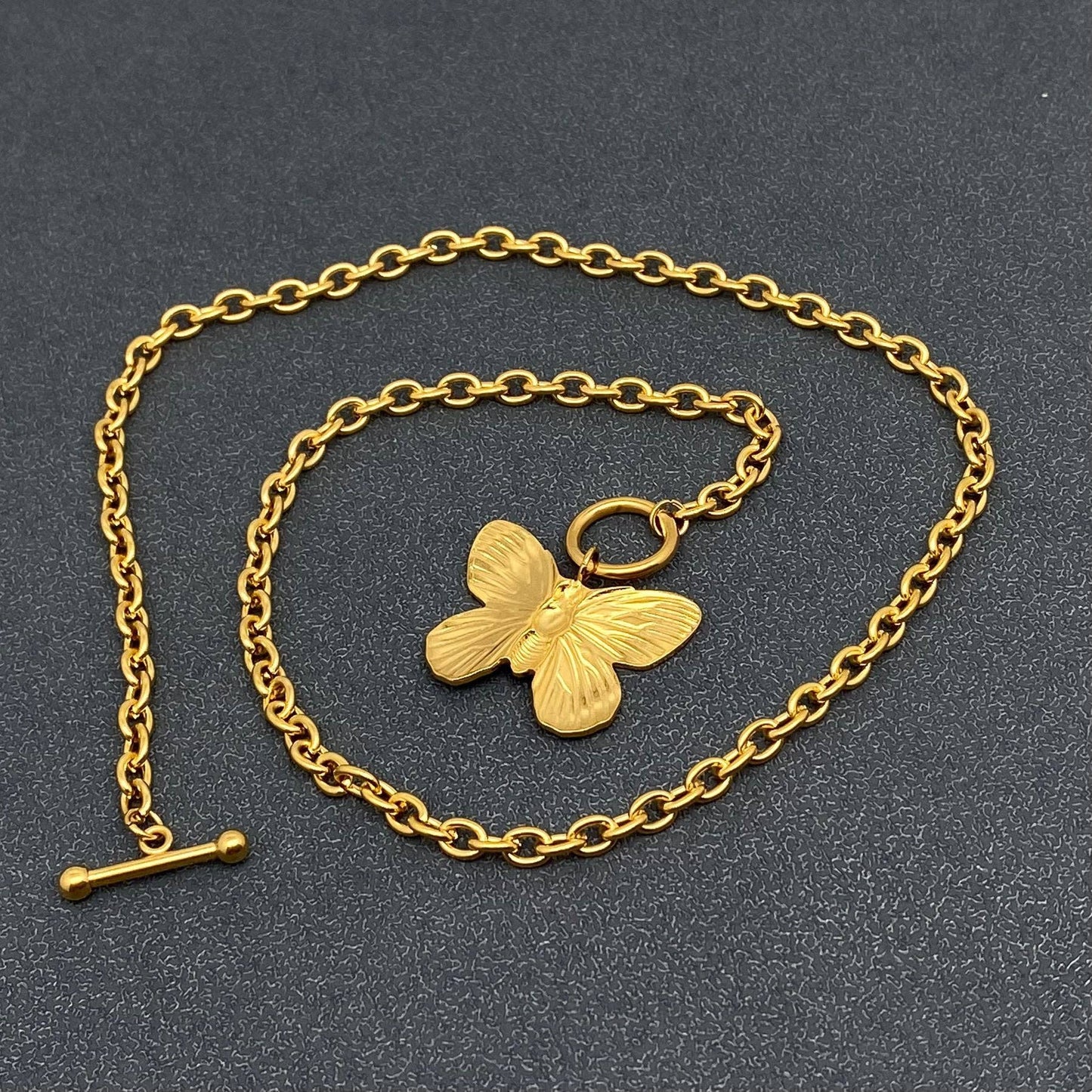 Gold chain toggle necklace with butterfly charm