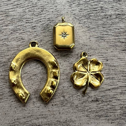 gold horseshoe, clover, and rectangle charms