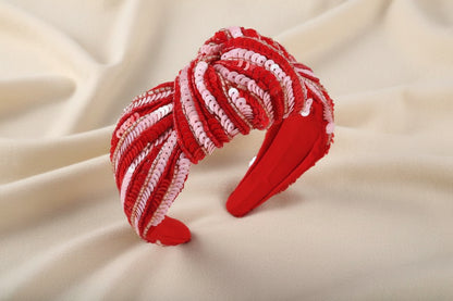 Red pink sequin stripe headband against an ivory background