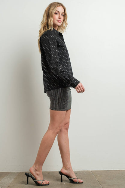 Black rhinestone embellished cotton blouse on woman with skirt