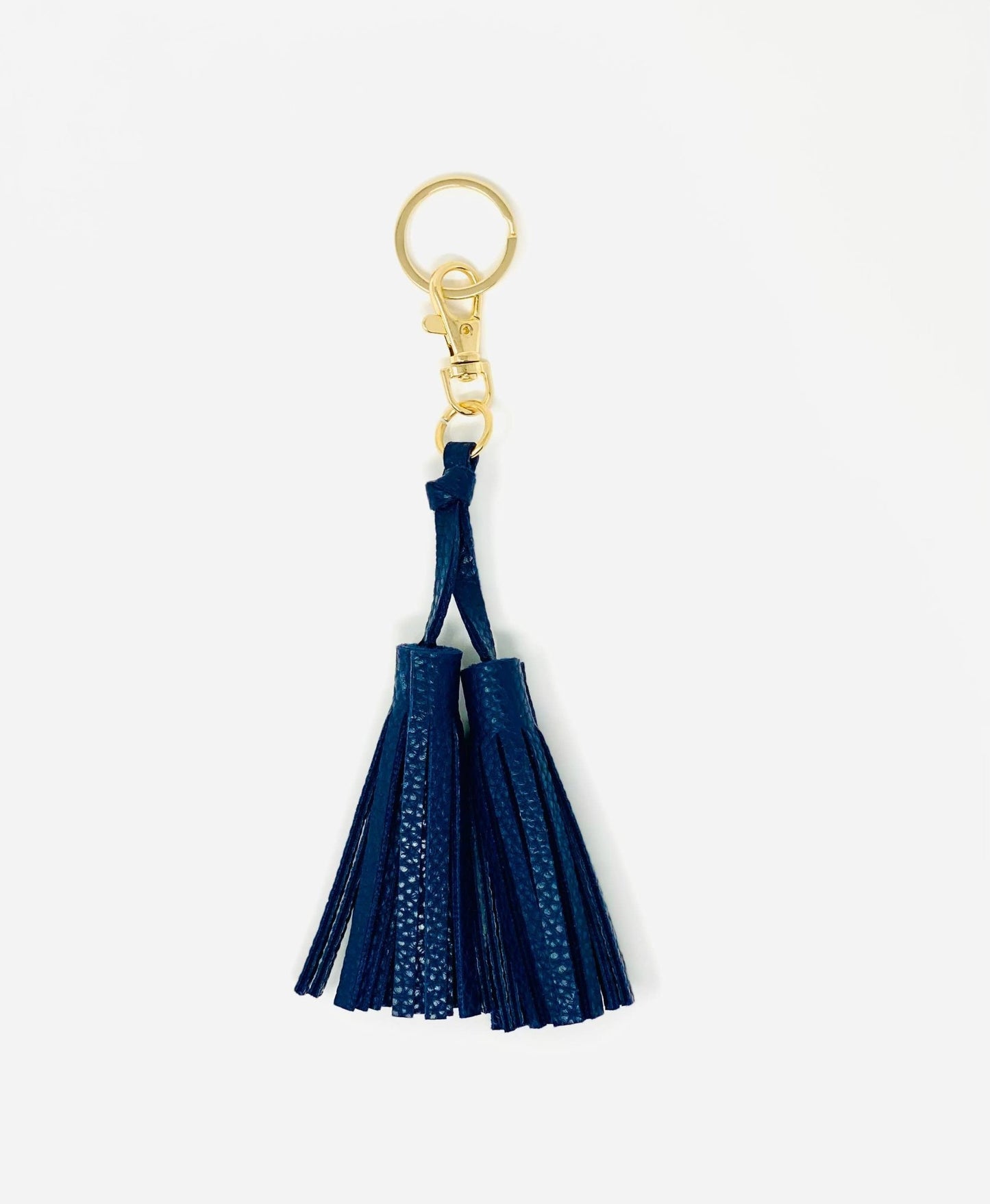 Navy tassel keychain with gold clasp on a white background